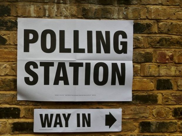 A sign giving directions to a polling station