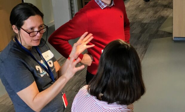 photograph of Lisa consulting with colleagues