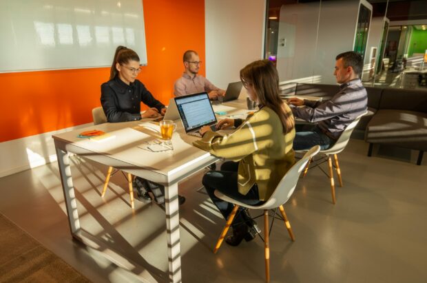 An image of a group of IT Operations people working at a desk together.