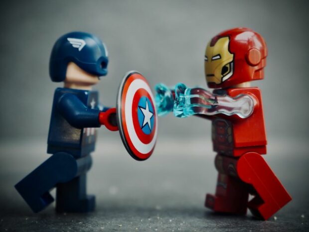 An image of toy Captain America and Iron Man Avengers characters battling each other.